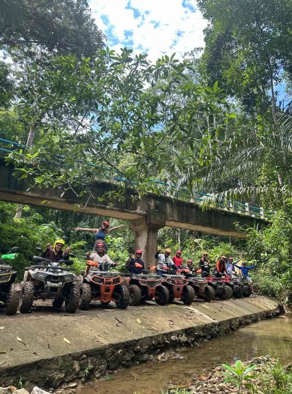 Komodo ATV Adventure ,Group crossing a river on ATVs during a Flores adventure tour ,East Indonesia cultural and adventure tours