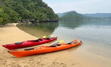 Kayaking through mangroves and rivers, exploring Flores' lush aquatic ecosystems.