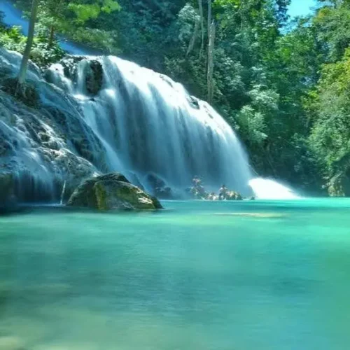 Cunca Plias waterfall cascading into a turquoise pool in Flores, Indonesia