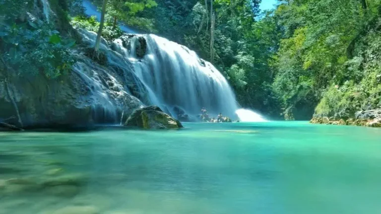 Cunca Plias waterfall cascading into a turquoise pool in Flores, Indonesia
