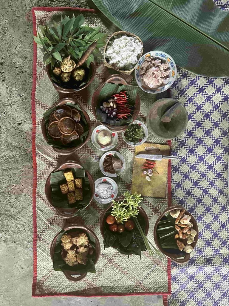 Guests participating in a traditional Indonesian cooking class in a Flores village