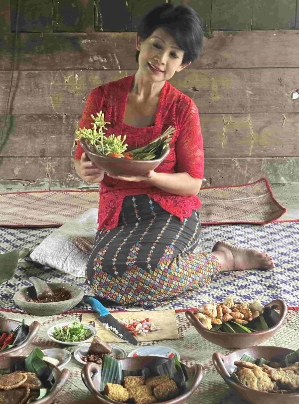 Traditional village kitchen setup in Flores, Indonesia with local cooking activity