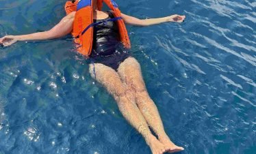 Snorkeler exploring vibrant coral reef in crystal-clear waters of Labuan Bajo,Labuan Bajo snorkeling trip