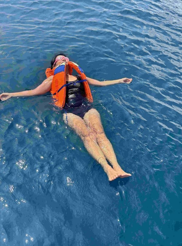 Snorkeler exploring vibrant coral reef in crystal-clear waters of Labuan Bajo,Labuan Bajo snorkeling trip