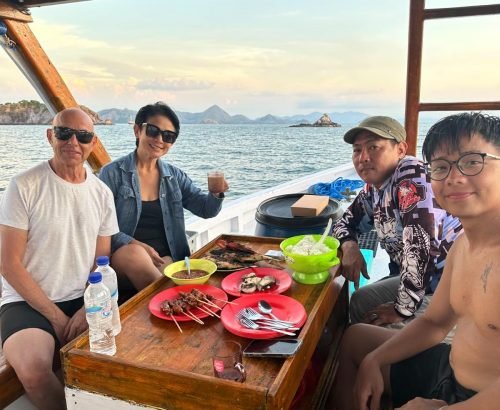 Private beachfront dining setup with sunset view on Flores Island