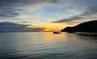 Traveler relaxing on a pristine tropical beach in Flores