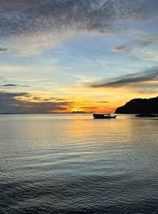 Traveler relaxing on a pristine tropical beach in Flores