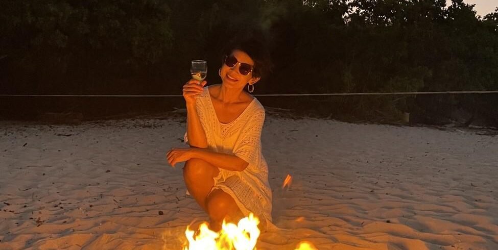 Flores Sunset Escape: Pasir Panjang Beach and Wae Ri I Beach Dinner & Bonfire Experience 4 A cozy dinner setup on the sand with a bonfire flickering nearby at Wae Ri I Beach.