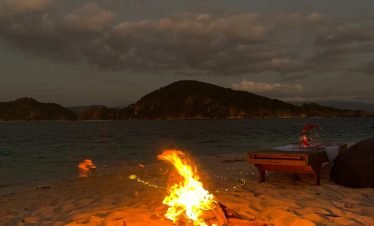 Sunset dinner at Pasir Panjang Beach with cozy bonfire in Flores