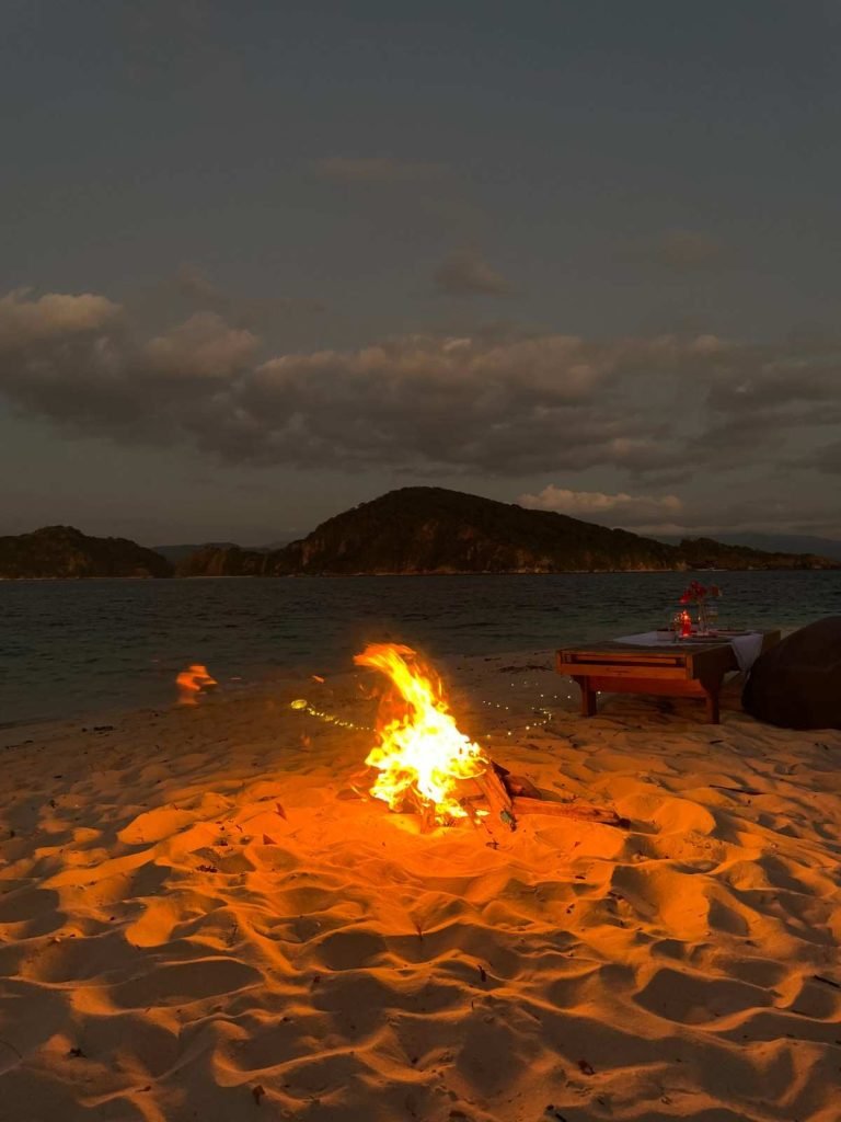 Sunset dinner at Pasir Panjang Beach with cozy bonfire in Flores