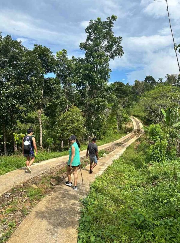 trekking-through-forest-village