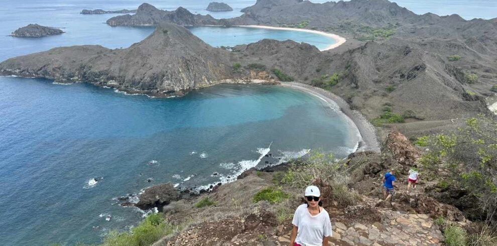 Tourists hiking up Padar Island with panoramic beach viewsKomodo Island Day Tour