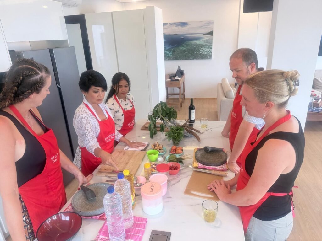 Group learning traditional recipes in Ina’s Kitchen cooking class Indonesia