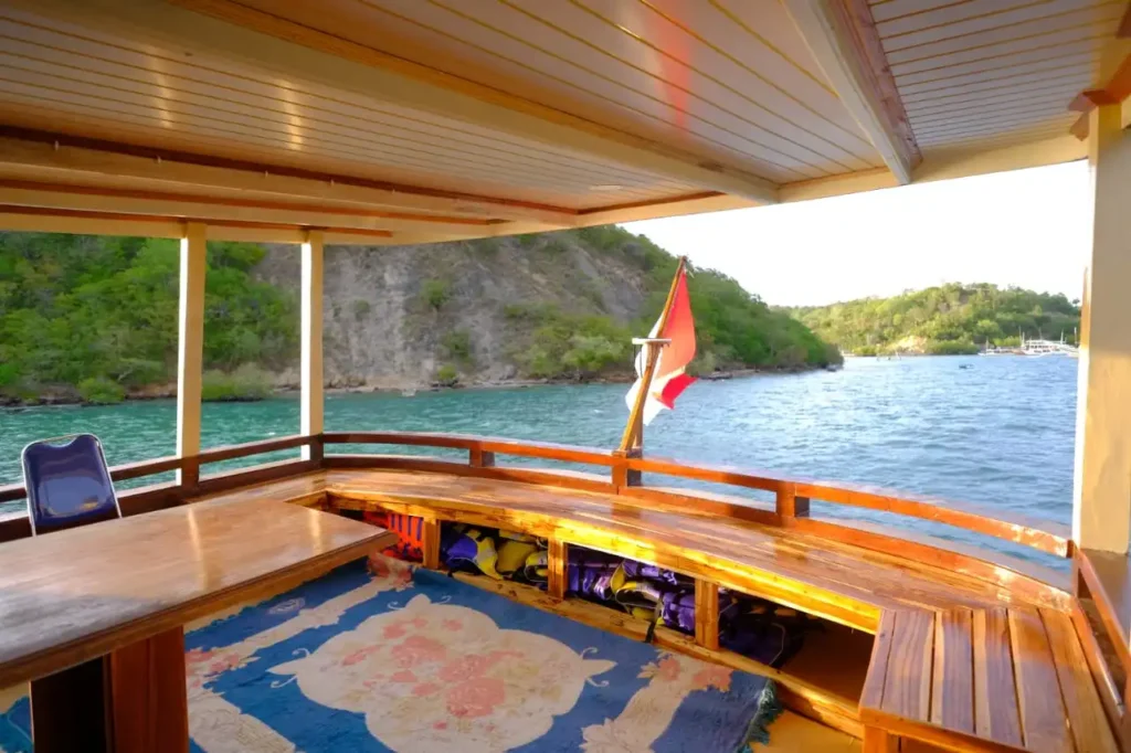 Luxury liveaboard cabin interior with ocean view and tropical island mountains in Komodo