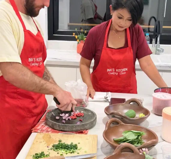Ina's Cooking Class 9 Cooking class participant preparing fresh Indonesian herbs, garlic, chili and shallots in Labuan Bajo.