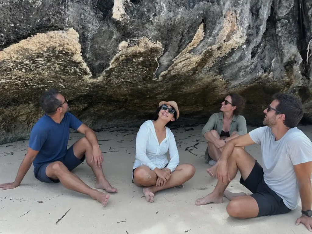 Travelers exploring a coastal rock cave during a Labuan Bajo island tour
