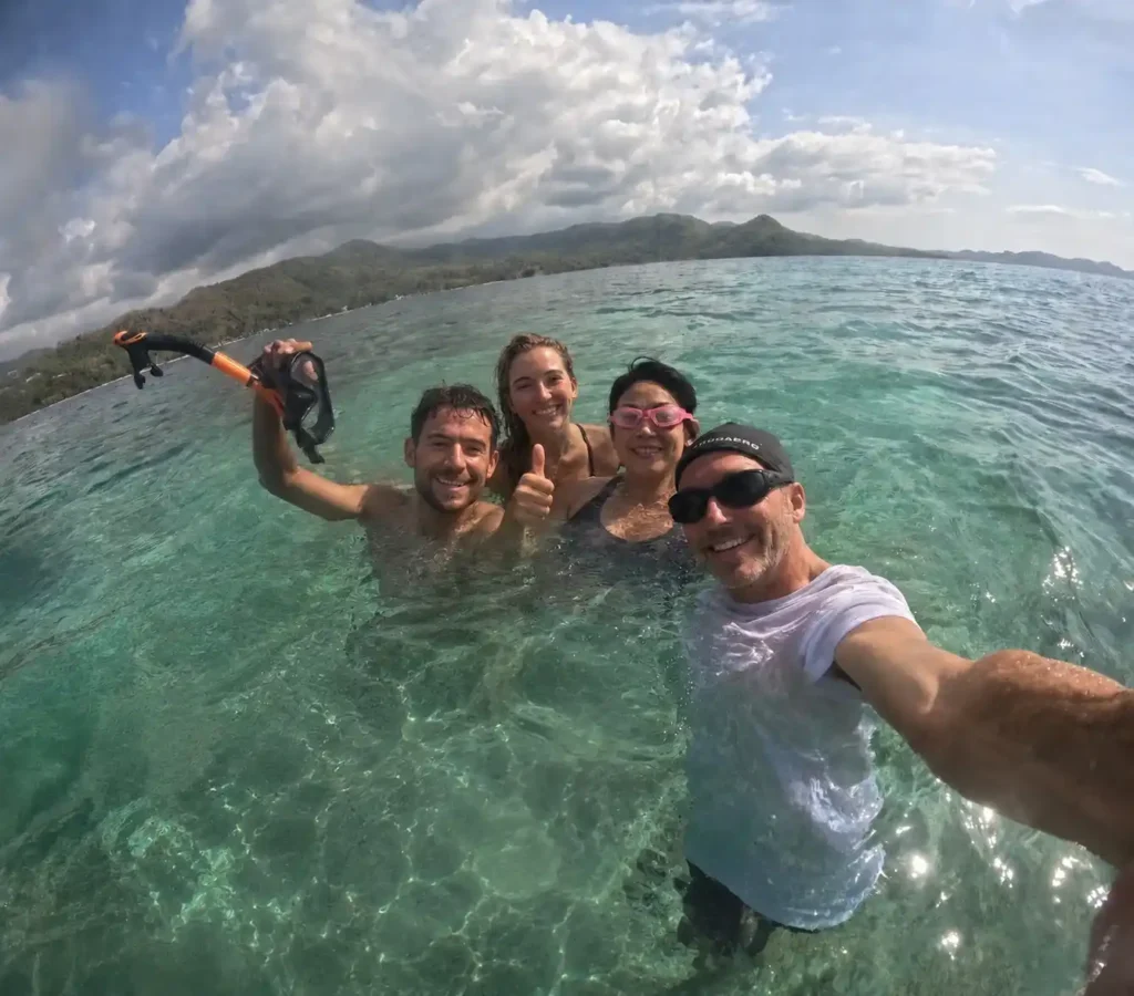 Travelers snorkeling in clear turquoise water near Labuan Bajo