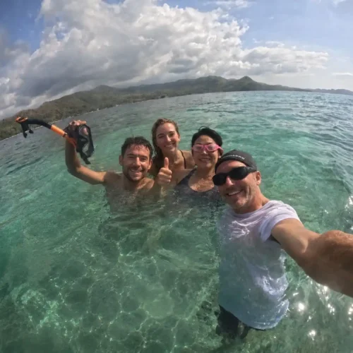 Travelers snorkeling in clear turquoise water near Labuan Bajo