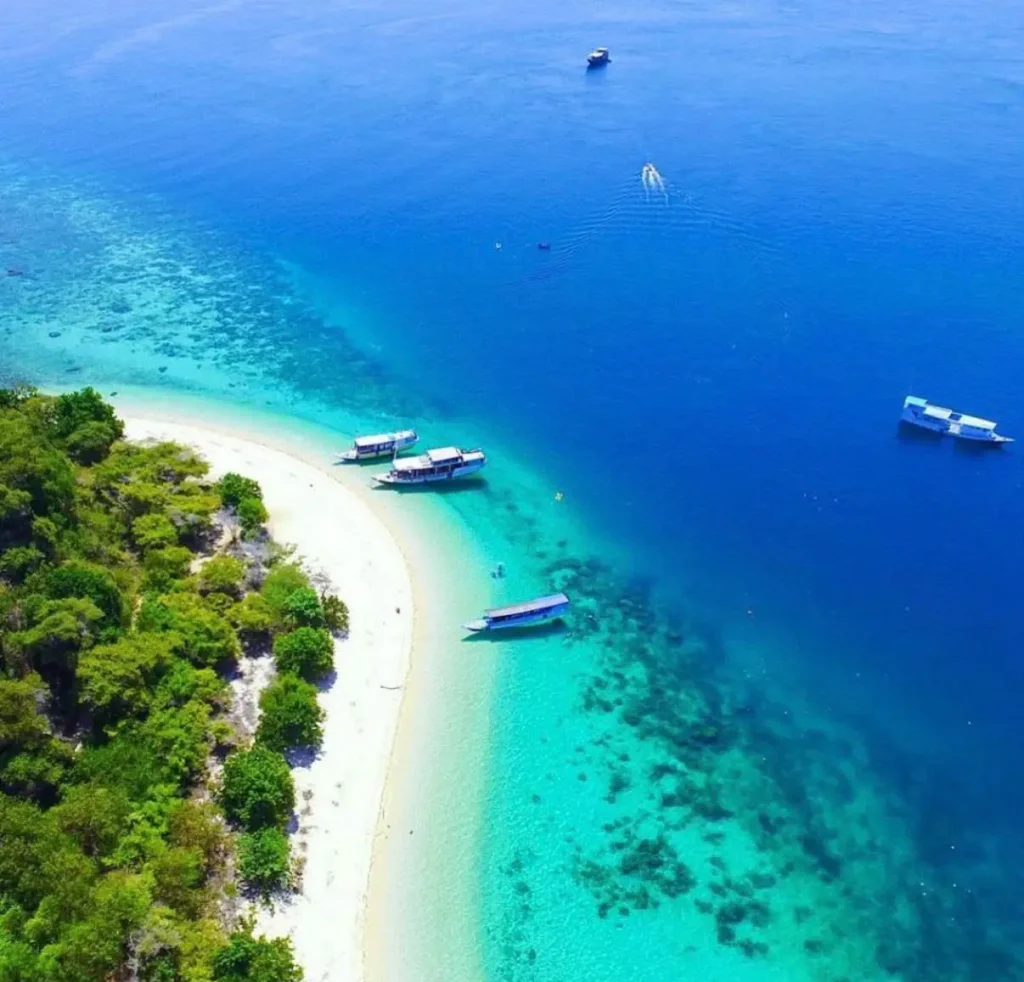 Aerial view of a tropical island beach and turquoise waters near Labuan Bajo