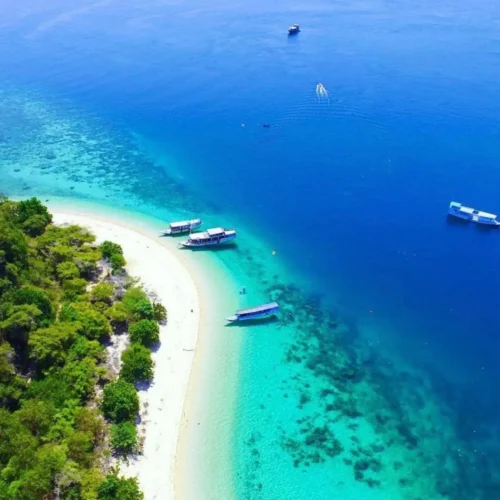 Aerial view of a tropical island beach and turquoise waters near Labuan Bajo