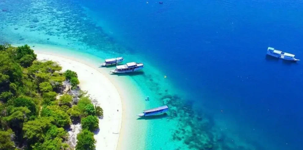 Aerial view of a tropical island beach and turquoise waters near Labuan Bajo