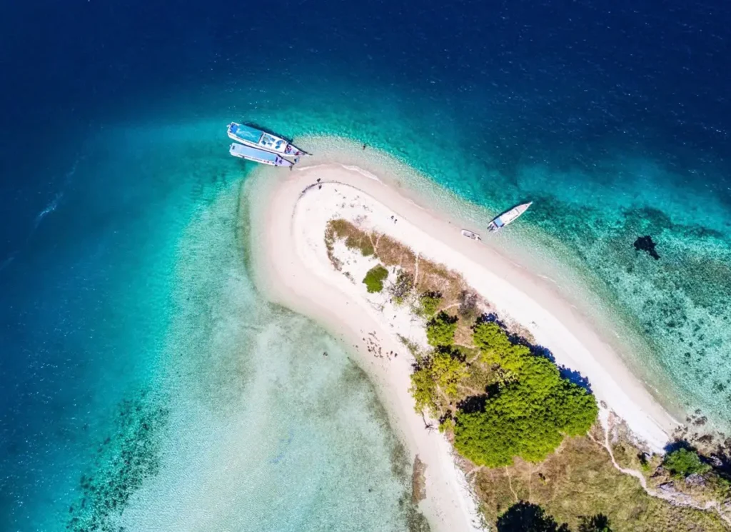 Aerial view of a tropical sandbar surrounded by turquoise water near Labuan Bajo
