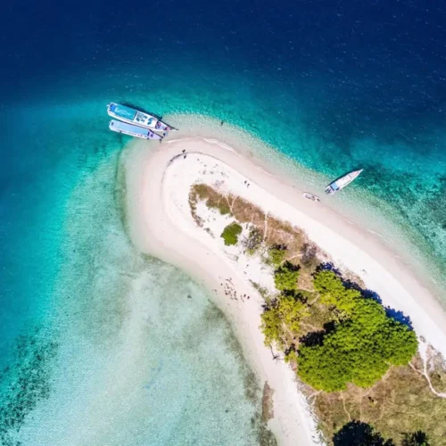 Aerial view of a tropical sandbar surrounded by turquoise water near Labuan Bajo